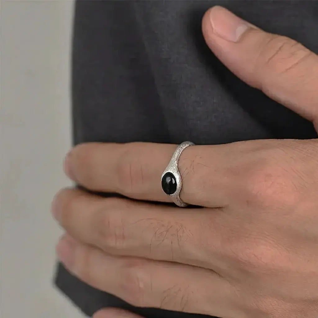 Silver ring with black onyx stone and curved band design