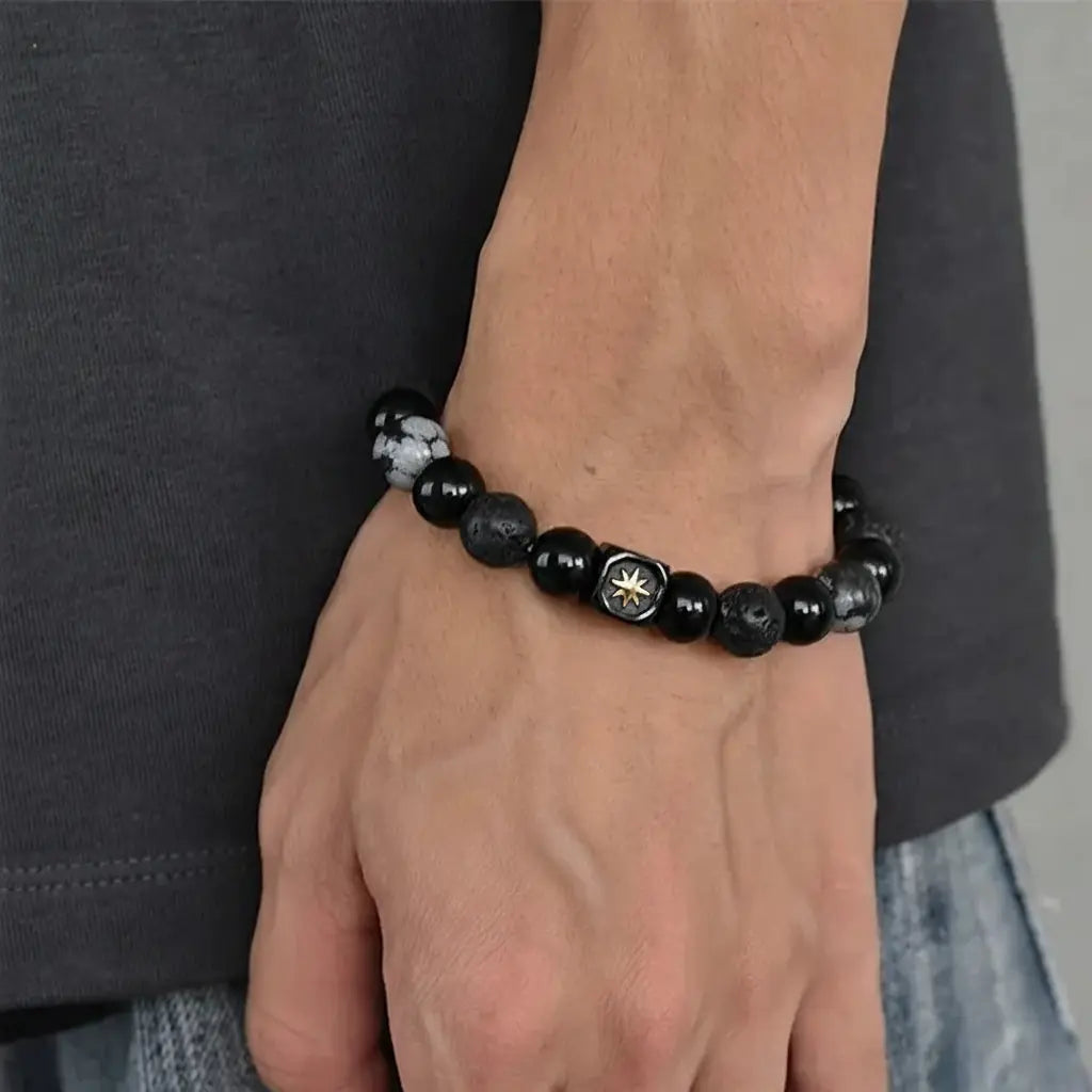 Black beaded bracelet with silver accents and a cannabis leaf design